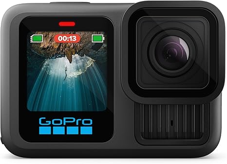 GoPro HERO13 Black action camera mounted on a snowboard helmet, capturing 5.3K cinematic footage on a steep snowy mountain run with pine trees in the background