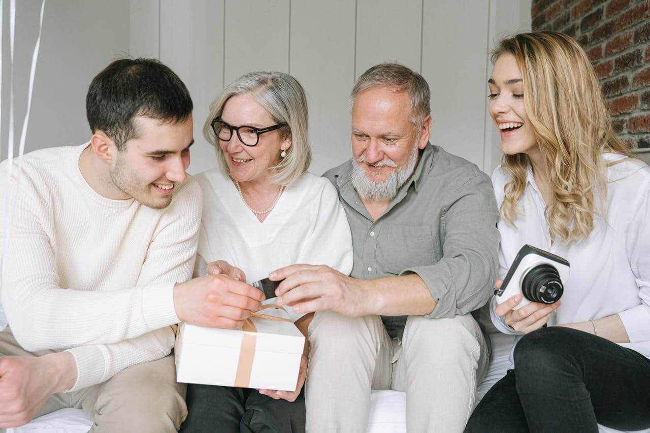 A men opening a gift, one of the Best Gifts for Men Under $100